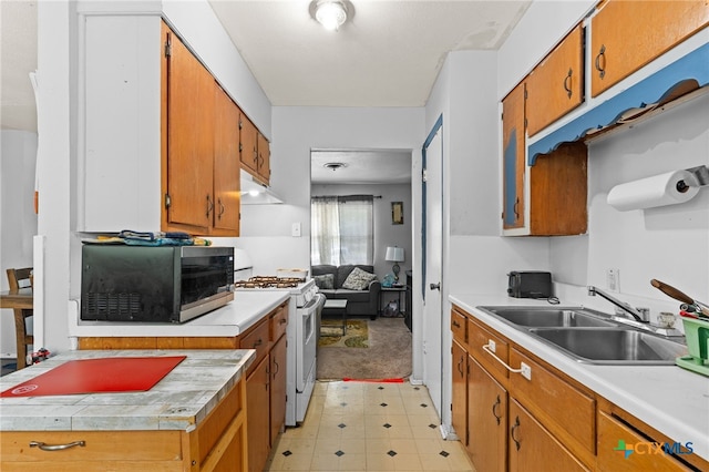 603 S 13th St, Copperas Cove, TX 76522 - kitchen with gas range gas stove, light countertops, and brown cabinets
