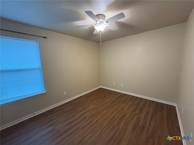 unfurnished room with ceiling fan, dark hardwood / wood-style flooring, and a textured ceiling