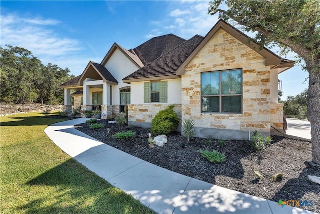 view of front of house featuring a front yard and covered porch