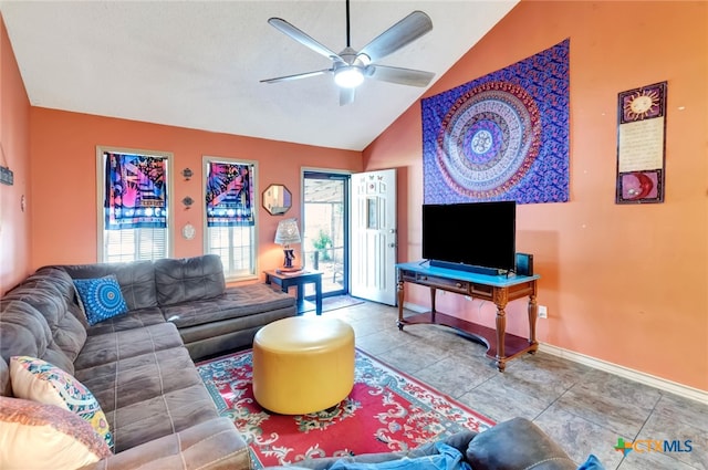 tiled living room featuring ceiling fan, vaulted ceiling, and a healthy amount of sunlight