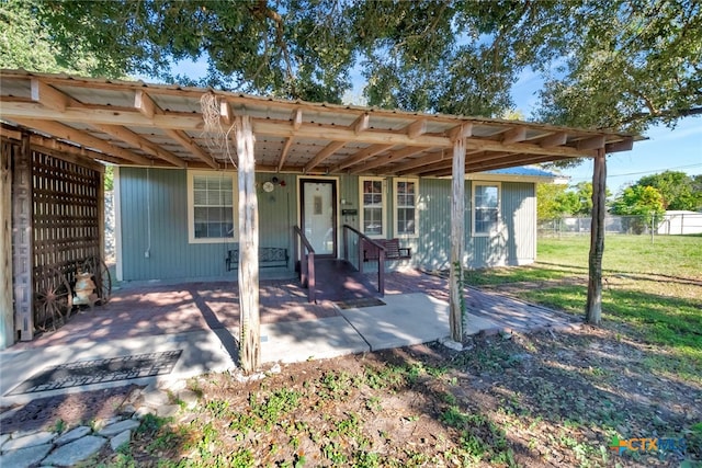 rear view of property with a patio and a yard