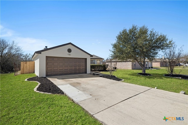 garage featuring driveway and fence