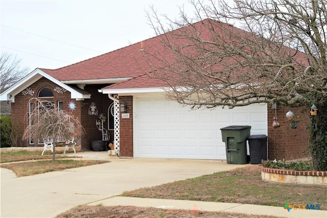 view of front of property with a shingled roof, brick siding, and driveway