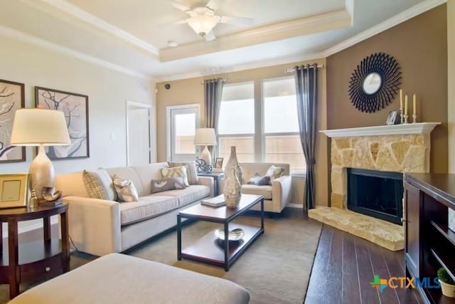 1575 Laila Ln, Belton, TX 76513 - living room with a tray ceiling, crown molding, a premium fireplace, wood finished floors, and a ceiling fan