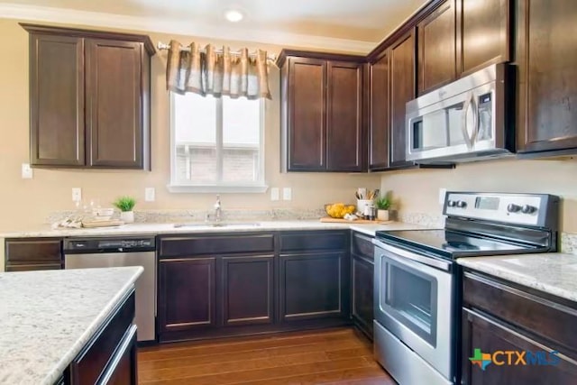 1575 Laila Ln, Belton, TX 76513 - kitchen with stainless steel appliances, a sink, dark wood-style floors, and dark brown cabinetry