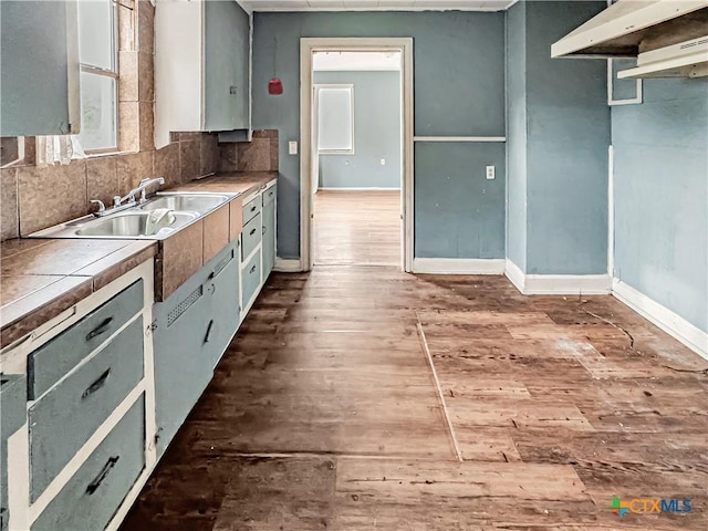 1805 E N St, Victoria, TX 77901 - kitchen featuring hardwood / wood-style floors, tile countertops, and tasteful backsplash