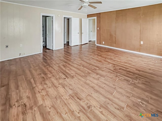 1805 E N St, Victoria, TX 77901 - unfurnished room featuring wood finished floors, a ceiling fan, ornamental molding, and wooden walls