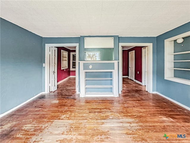 1805 E N St, Victoria, TX 77901 - spare room with built in features and wood finished floors