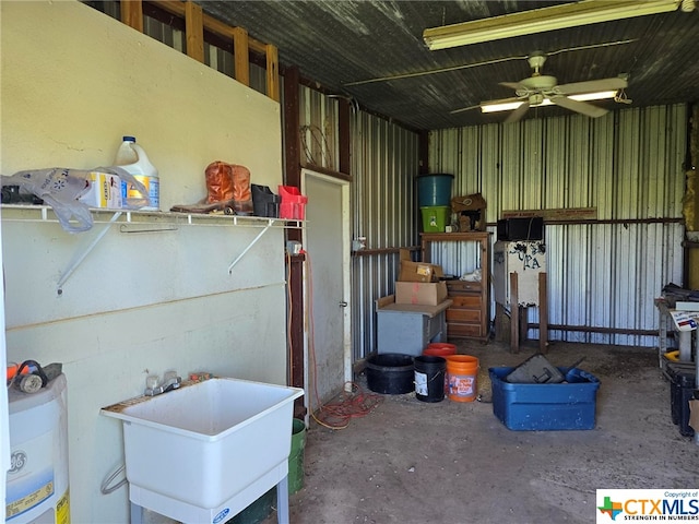 interior space with electric water heater, sink, and ceiling fan