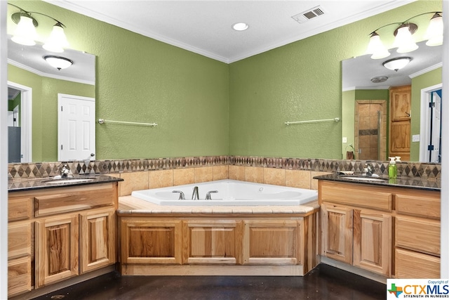 bathroom featuring vanity, a bathing tub, and ornamental molding