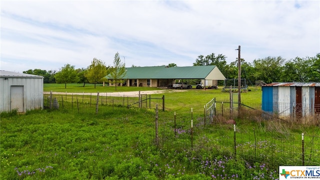 view of yard featuring an outbuilding and a rural view