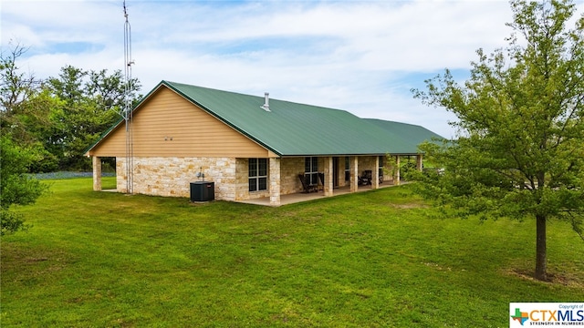 back of property featuring central AC, a patio area, and a yard