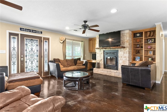 living room with ornamental molding, a stone fireplace, a textured ceiling, and ceiling fan