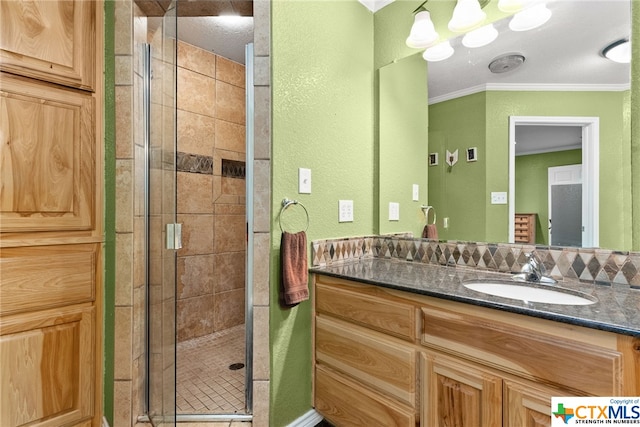 bathroom featuring walk in shower, vanity, a textured ceiling, and ornamental molding