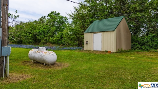 view of outbuilding featuring a yard