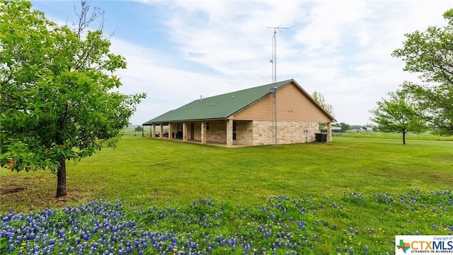 view of property exterior with a lawn