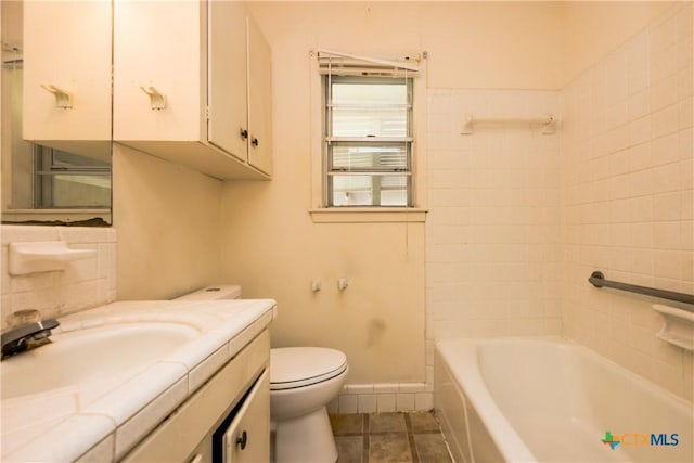 bathroom featuring tile patterned flooring, vanity, and toilet