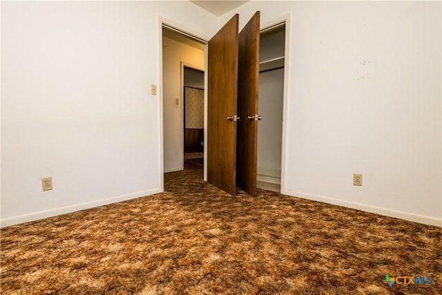 unfurnished bedroom featuring dark colored carpet