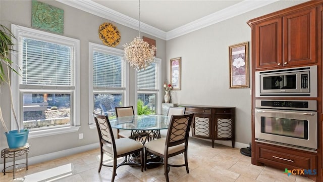 dining space with a wealth of natural light, a chandelier, baseboards, and ornamental molding