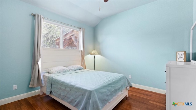 bedroom featuring lofted ceiling, wood finished floors, baseboards, and ceiling fan