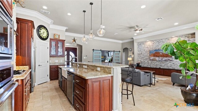 kitchen featuring stone tile floors, visible vents, a breakfast bar, arched walkways, and appliances with stainless steel finishes