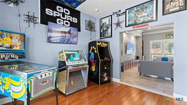 recreation room featuring crown molding and wood finished floors