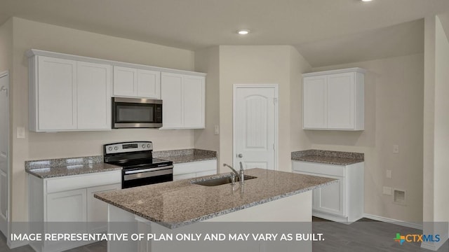 kitchen with light stone counters, stainless steel appliances, white cabinets, and a sink