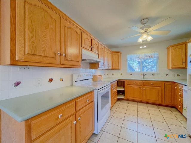 kitchen with white electric range oven, light tile patterned flooring, sink, ceiling fan, and decorative backsplash