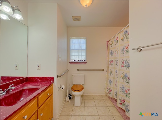 bathroom featuring toilet, vanity, and tile patterned flooring