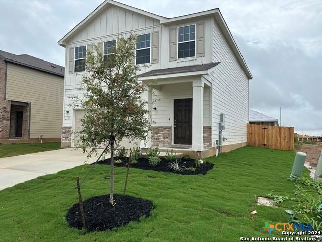 2537 Windle Ln, Seguin, TX 78155 - view of front of house with an attached garage, board and batten siding, and driveway