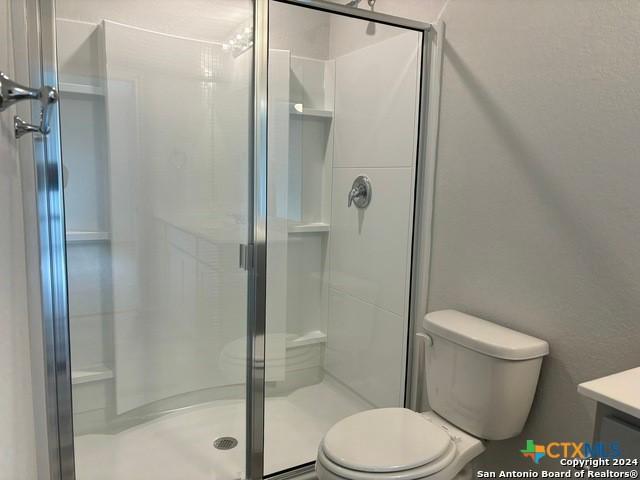 2537 Windle Ln, Seguin, TX 78155 - bathroom featuring toilet, a shower stall, and vanity