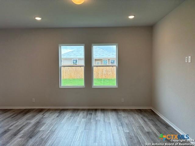 2537 Windle Ln, Seguin, TX 78155 - spare room featuring wood finished floors, baseboards, and recessed lighting