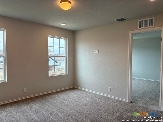 empty room featuring carpet flooring