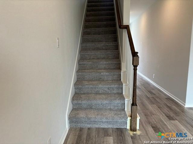 2537 Windle Ln, Seguin, TX 78155 - stairway with wood finished floors and baseboards