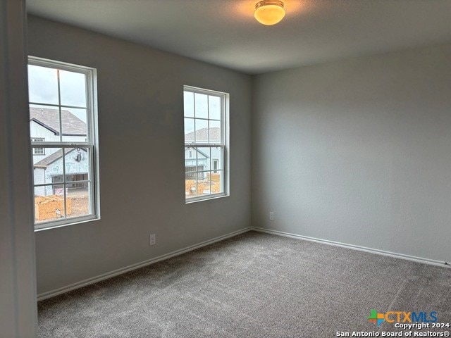 carpeted spare room with plenty of natural light