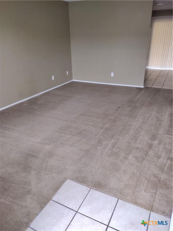 unfurnished room featuring tile patterned flooring