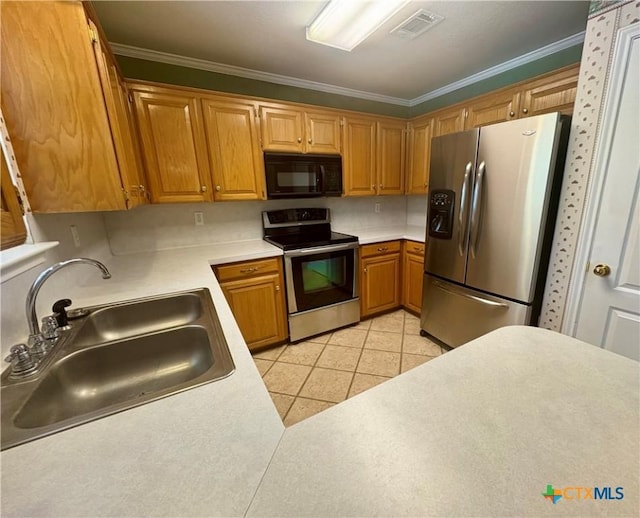 kitchen with visible vents, a sink, light countertops, light tile patterned floors, and stainless steel appliances