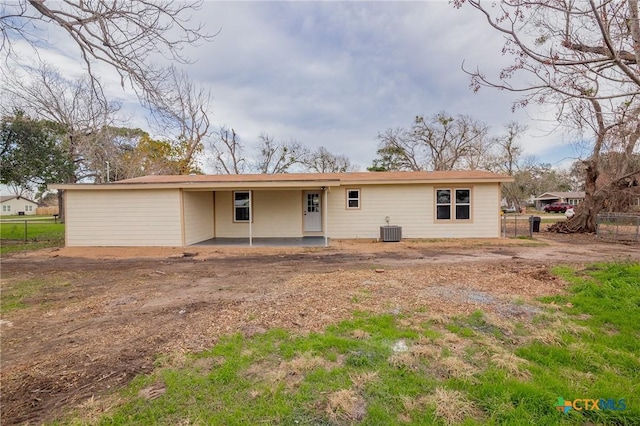 rear view of house featuring a patio area and cooling unit