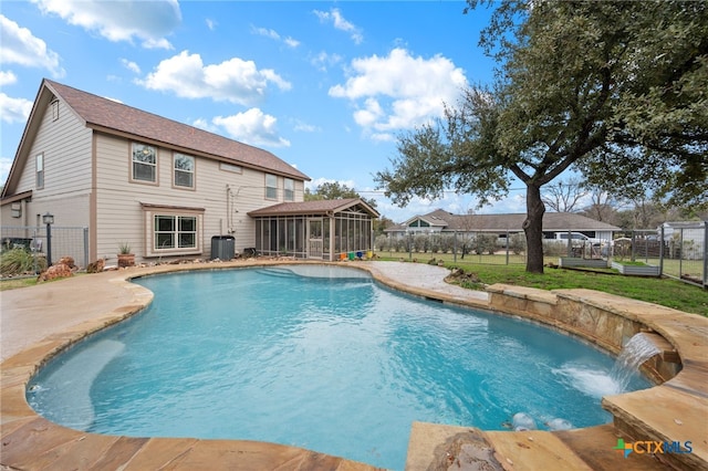 view of pool with central air condition unit, a fenced backyard, a yard, a sunroom, and a fenced in pool