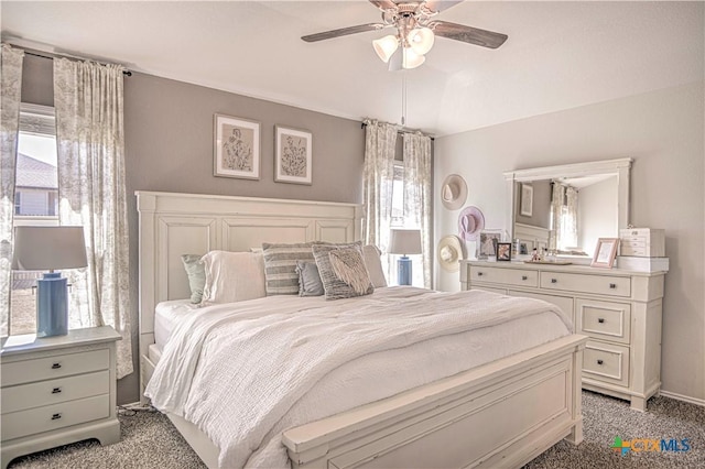 bedroom with multiple windows, light colored carpet, and ceiling fan