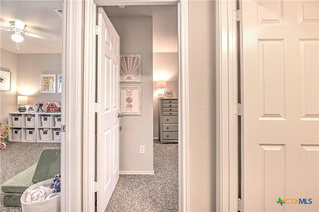 hall with baseboards and carpet floors