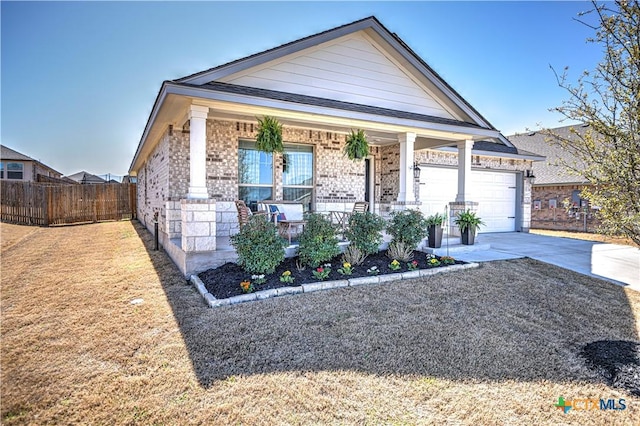 view of front of home featuring brick siding, fence, a porch, driveway, and an attached garage