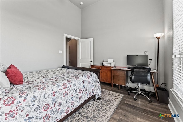 bedroom featuring dark hardwood / wood-style floors and high vaulted ceiling