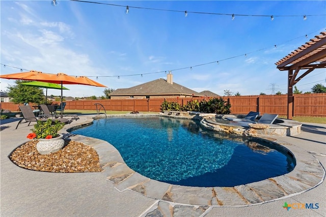 view of pool with a patio area and an in ground hot tub