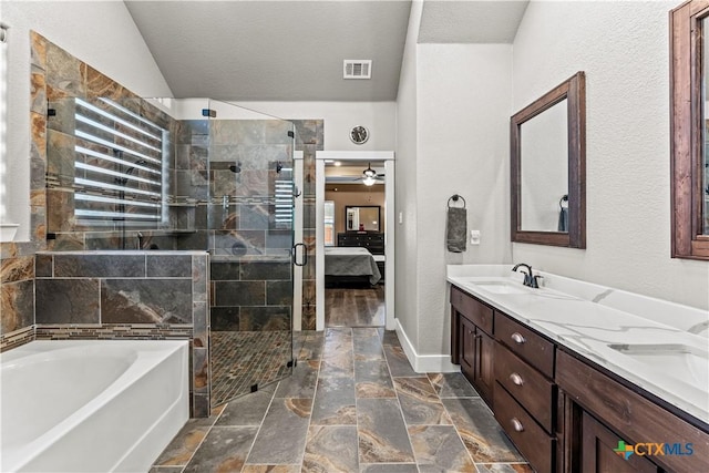 bathroom featuring vanity, vaulted ceiling, and separate shower and tub