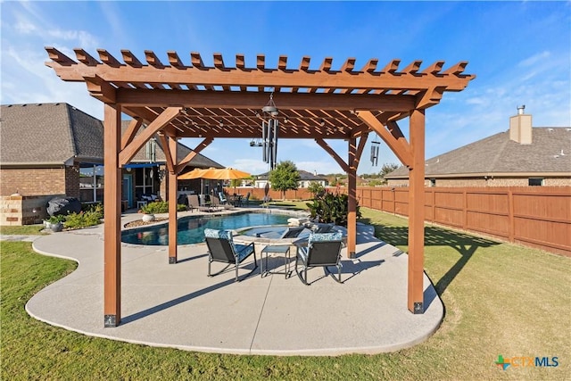 view of swimming pool featuring a jacuzzi, a yard, a pergola, and a patio area