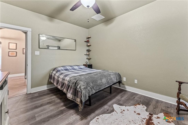 bedroom with ceiling fan and dark hardwood / wood-style flooring