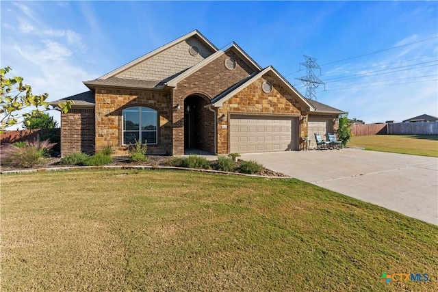 view of front of home with a garage and a front lawn