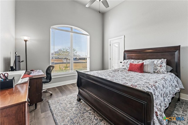 bedroom featuring ceiling fan, dark hardwood / wood-style floors, and vaulted ceiling