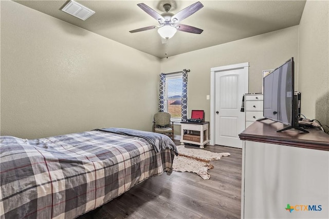 bedroom with hardwood / wood-style flooring and ceiling fan